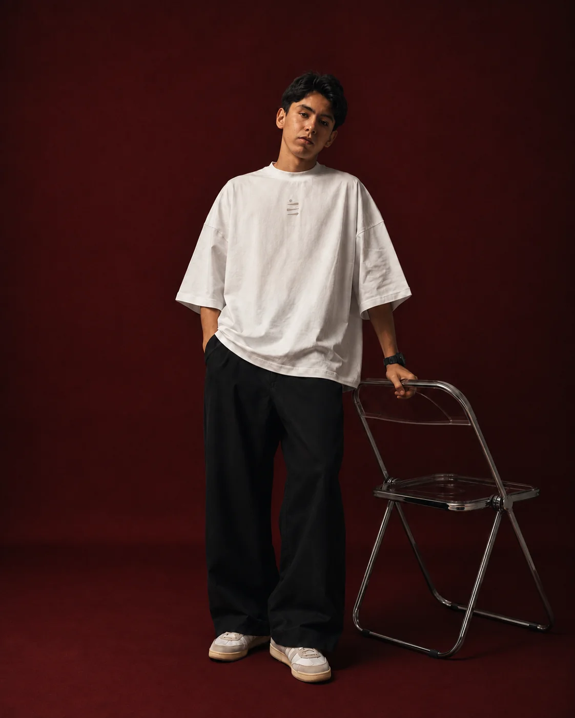 DIV3NITY model in a white T-shirt against a deep red backdrop